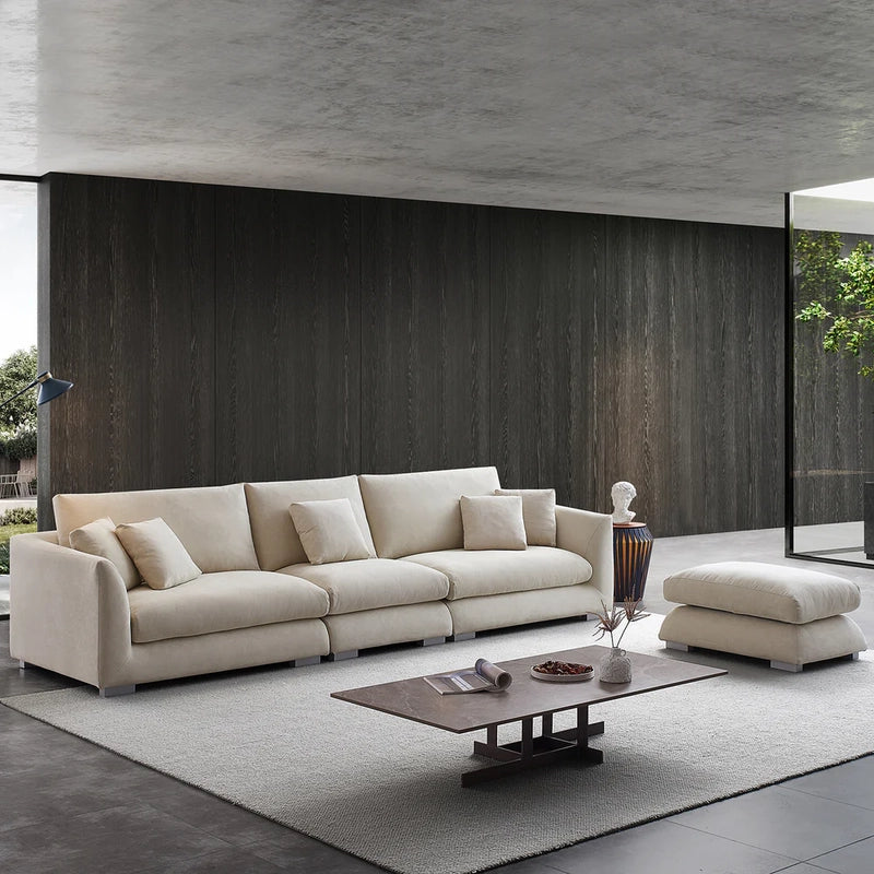 Its gently sloped armrests and low metal legs create a light, modern visual flow. Built with sturdy neem wood and pocket springs, this luxury sofa is both pet-friendly and easy to maintain.