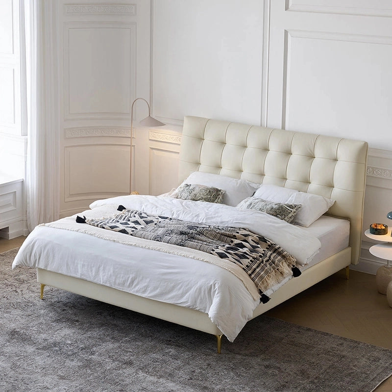 Its tall, tufted headboard in taupe leatherette provides both back support and a bold aesthetic, while the clean frame and metal legs create a balanced, streamlined profile. 