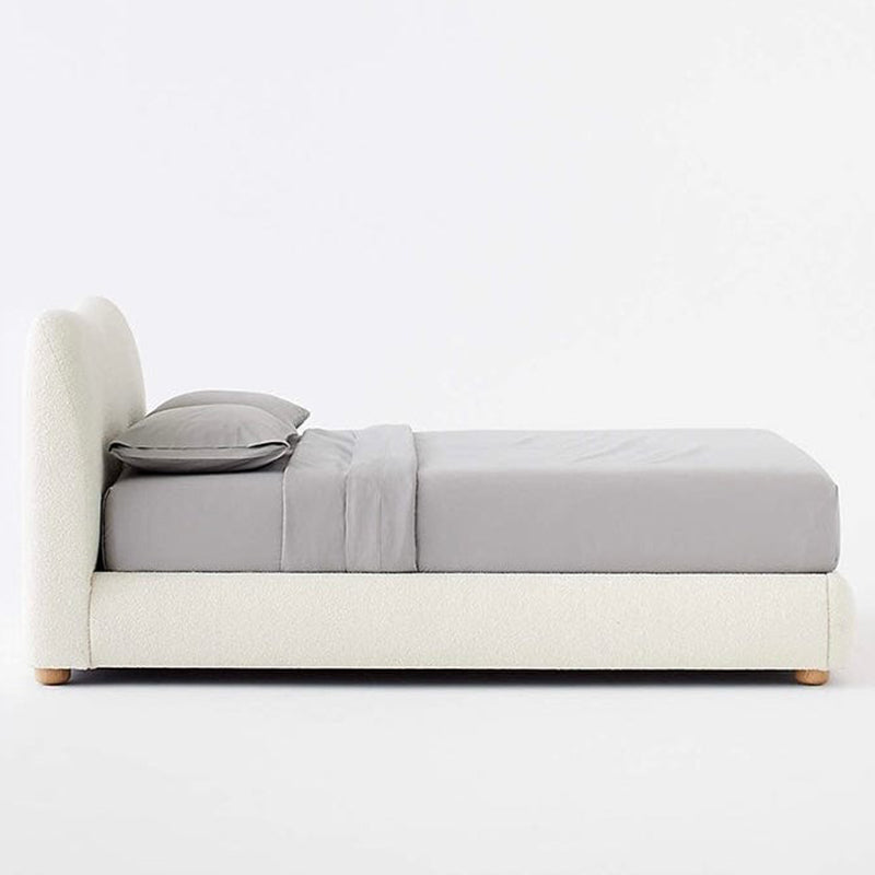 The low-profile design sits atop stubby natural wooden legs, adding a light footprint.