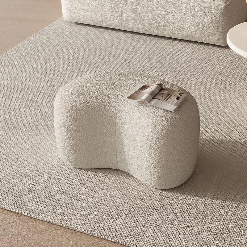 Organic pebble shape ottoman with pouf ottoman and footrest in off-white bouclé