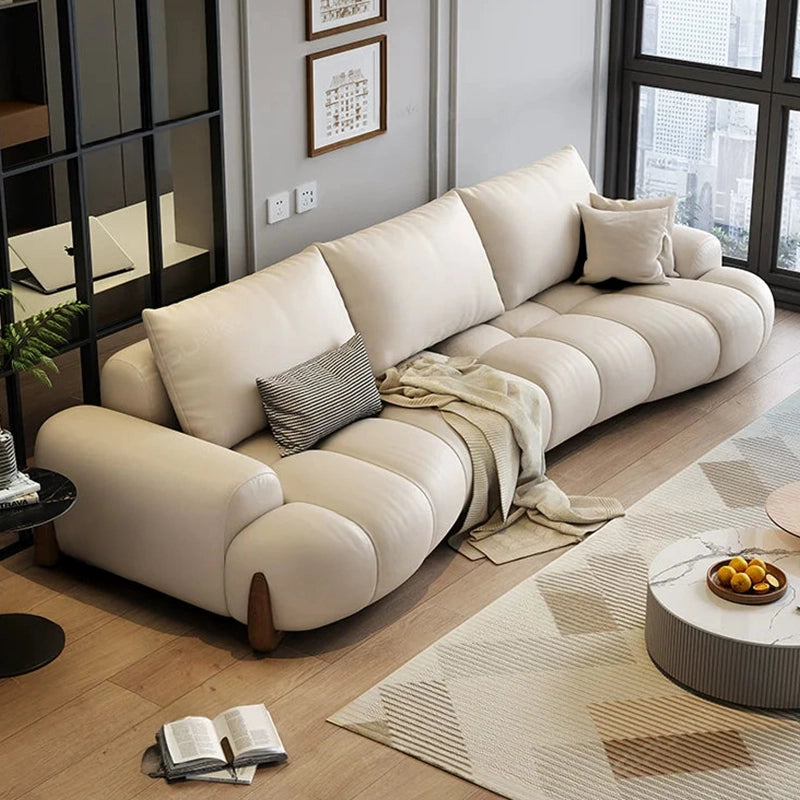 The smooth channel stitching, low-profile wood legs, and pillowy build make this luxury couch a functional centrepiece