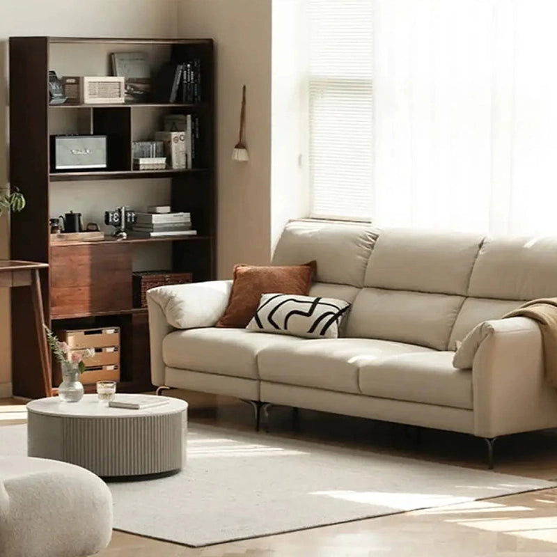 Plush armrest curves and black metal legs – modern sofa design, leather sofa, contemporary shape