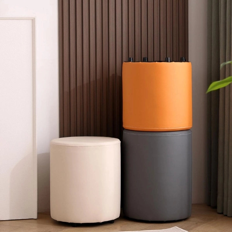 The Icarus design serves as both a pouf seat and ottoman stool, wrapped in faux leather upholstery across modern shades like beige, orange, and grey.