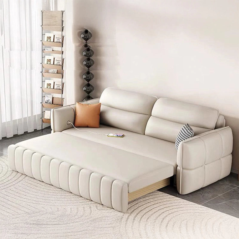 The linear silhouette, vertical channel stitching, and box-quilted arms add a clean, urban aesthetic.