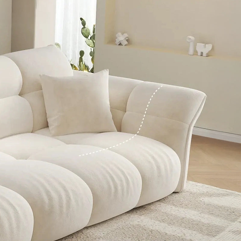The ivory beige upholstery is visually warm and smooth, combining comfort-first fabric with plush seat cushioning