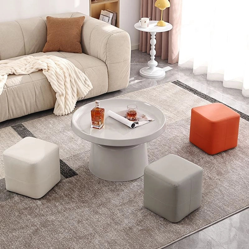 This pouffe-style ottoman delivers a compact yet impactful touch to any room, blending soft edges and cube silhouette with a faux leather finish available in rich shades of black, ivory, orange, taupe, and brown. 